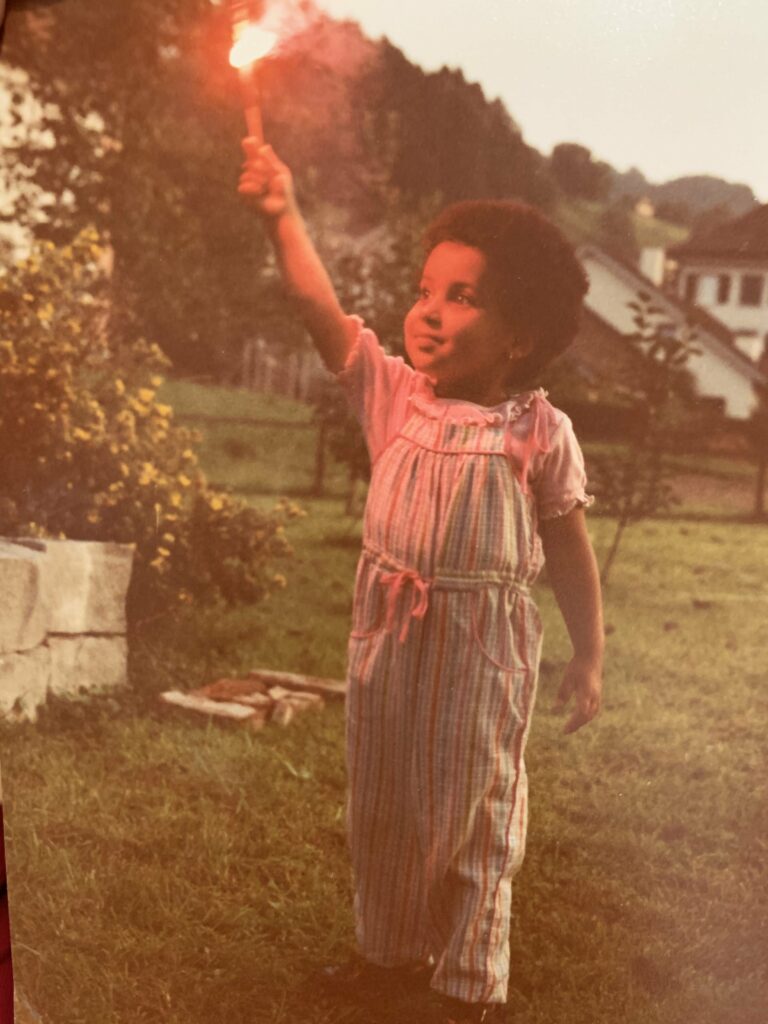 About the photo : I think I was about three or four when this picture was taken in my auntie’s backyard in Switzerland. The sense of wonder that comes with being a kid is so visceral and all encompassing and you can see it in the expression on my face. For me, that’s what dreams are made of&nbsp;— that child-like spirit, that spark.